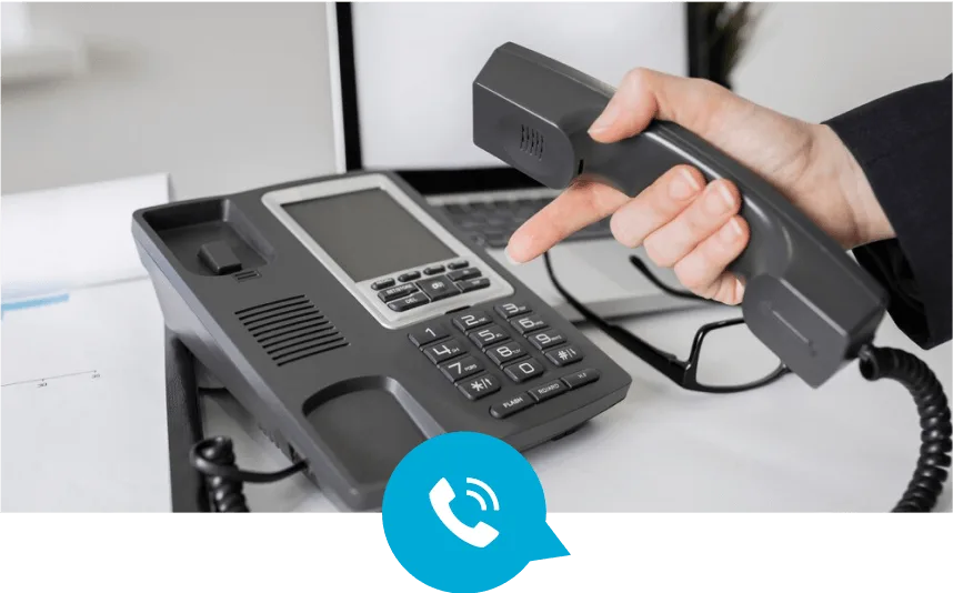 Man is holding the telephone and pointing to button for call
