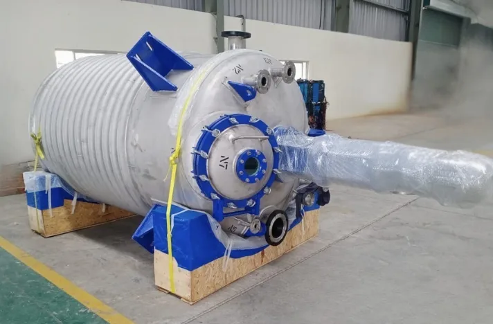 a big high-pressure reactor in blue colour put on a wooden pallet
