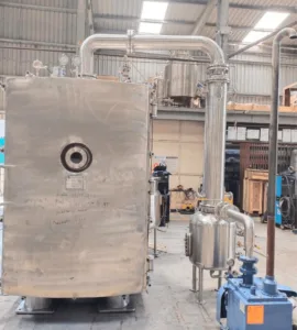 Industrial vacuum tray dryer in a manufacturing facility