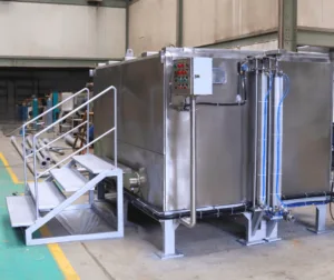 Large-scale automated quench tank with control panel, pipelines and stair access for industrial heat treatment processes
